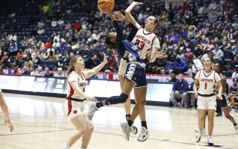 Lady Devil Niya Moon attempts to attack the basket but is blocked and knocked down by a Rabun County defender during the GHSA state championship game in Macon Thursday, March 10. (Photo by Scoggins)