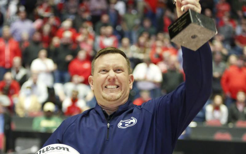 Lady Devils Head Coach Josh Jones holds up the GHSA State Championship trophy to the Elbert County crowd after defeating Rabun County 52-44 to bring home the program’s first-ever state title. Jones has been the Lady Devils’ head coach for the last four years after being named to the position in 2018. Before being head coach, Jones served as an assistant at the high school under Alton Smith and Wes Greer. (Photo by Scoggins)