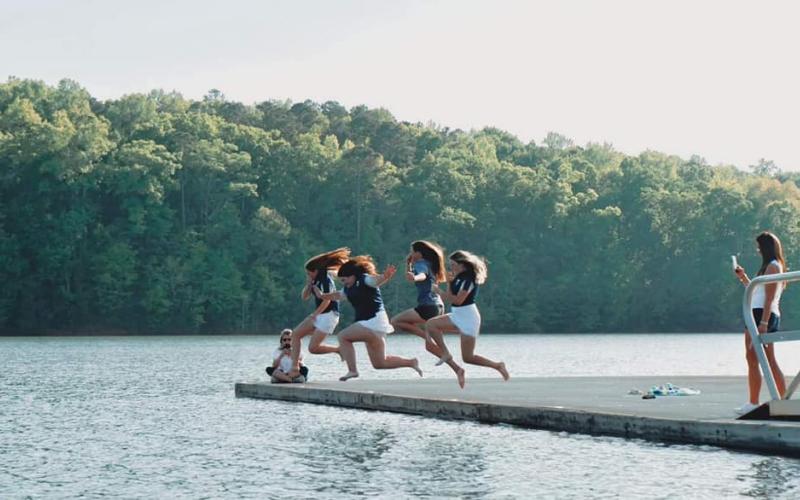 After winning the Area 4AA championship Wednesday, April 27, the Lady Devils golf team took a plunge into Lake Richard B. Russell. Taking the plunge are Lady Devils (L-R) Emalise Andrews, Ava Dye, Abby Bryant and Ellie Wheeler.