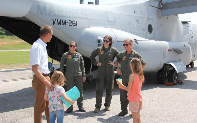 Mayor Daniel Graves, along with daughters Auri and Zola, met the crew of one of the Marine Corps MV-22 Ospreys that landed at the Elbert County Airport last week. (Photo by Wells)