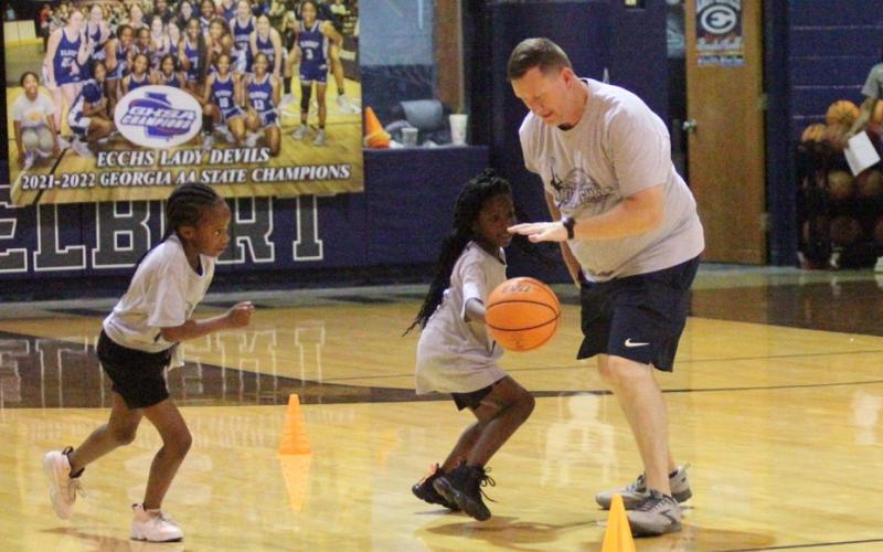 Lady Devils Head Coach Josh Jones practices skills with Lady Devil Youth Campers (L-R) Skylar Henderson and Kassydi Mattox during the state champions’ camp at the end of June in the Inferno. (Photos by Wells)