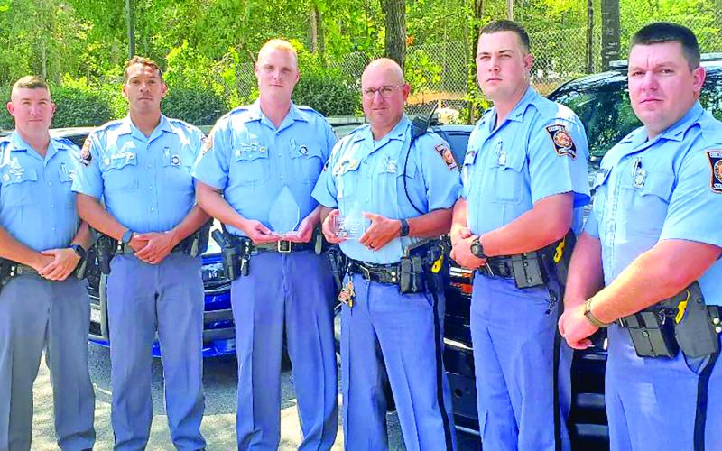 Georgia State Patrol troopers — Cory Andrews, Brad Cuevas, Dustin Welborn, Kiefer Smith, Bryan Randall, Jesse Lamb and Matthew Bradley — from Post 52 show the trophies they received from MADD Georgia for their efforts combating drunk driving in 2021.