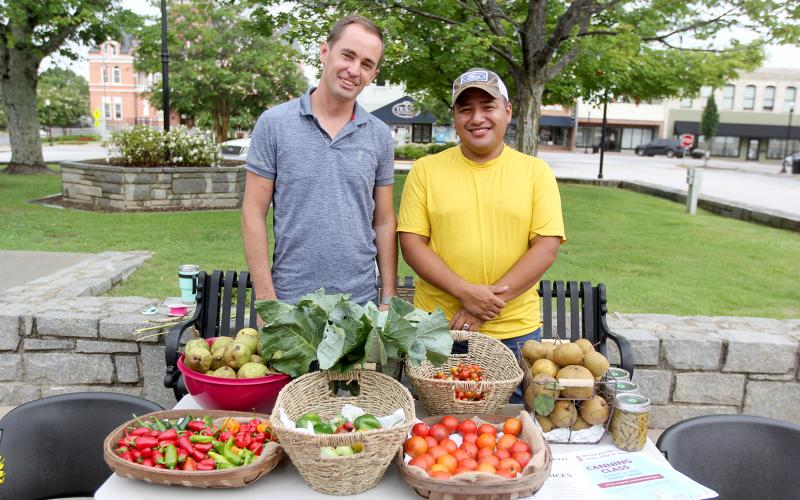 (L-R) Jessie Powers and Mauricio Cortez, of Powers Farm and Ranch, bring farm-fresh vegetables and beef to the farmers market each Wednesday. (Photos by Scoggins)