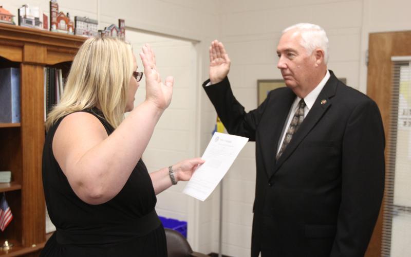 David Hunt (right) was sworn in by Elbert County Probate Judge Stephanie Hewell (left) Tuesday, Aug. 16 as the newest commissioner on the Elbert County Board of Commissioners. Hunt was recently appointed by the board to fill the remaining term on the District 1 seat after it was vacated due to former commissioner Horace Harper’s passing in June. (Photo by Scoggins)