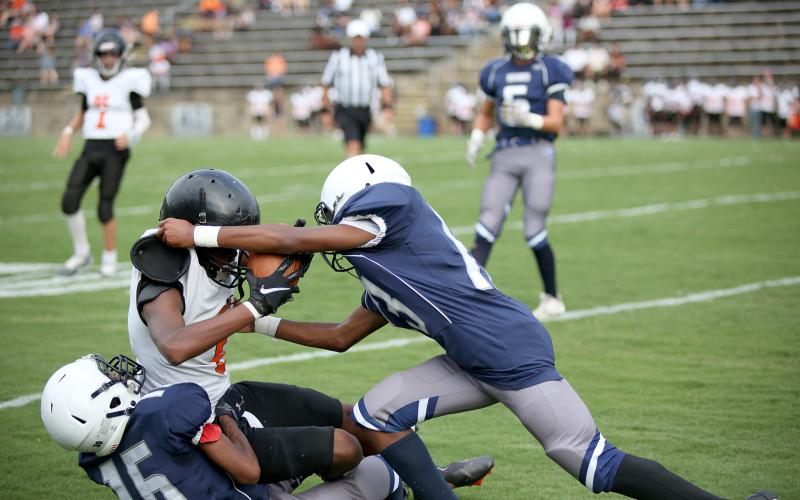 La’Dricus Jackson (No. 15) and Mekhai Washington (No. 13) tackle a Hart County player during the Aug. 20 game in the Granite Bowl. The Rams will travel to Stephens County Sept. 1 for their second game of the season. (Photo by Wells)
