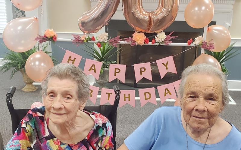 Juanita Wilder Adams Scruton (right) smiles for a picture with her oldest sister, Betty Wilder Looney (left) during her surprise 90th Birthday party. Looney will celebrate her 94th birthday Aug. 19.
