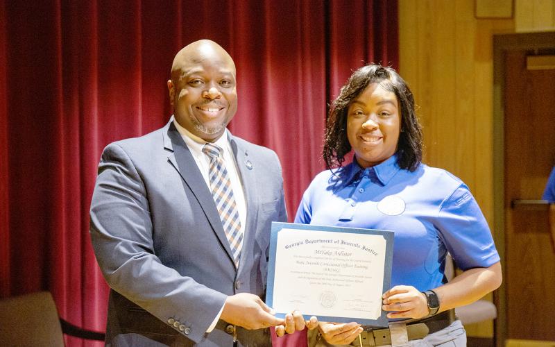 Elberton’s MiYako Ardister (right) recently graduated as a juvenile corrections officer. Ardister is pictured with Georgia Department of Juvenile Justice Commissioner Tyrone Oliver.