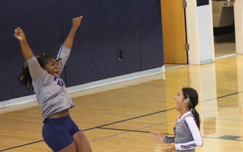 Jurnee Porter jumps for joy as Sophia Vargas laughs at Porter’s reaction during the Lady Rams’ win over Stephens County Middle School Aug. 31. (Photo by Wells)