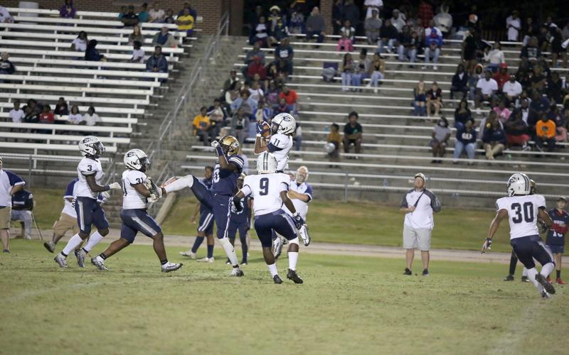 Sophomore Jermaine Sims (No. 3), senior DeCorius “Bubba” Heard (No. 31) and senior Keithshun Tate (No. 9) watch as senior Christian Harris (No. 11) intercepts a Warrior ball during Friday’s 21-3 win over Jefferson County High School. (Photo by Scoggins)