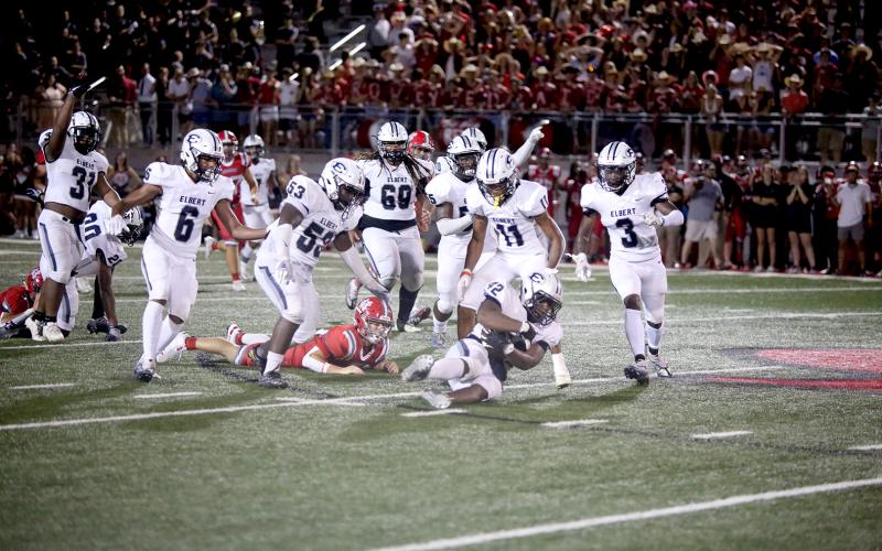 A host of Blue Devils celebrate as Gilbert Fortson (No. 42) recovers a fumbled ball from Madison County’s Red Raiders during the Devils’ 48-34 win over the county-line rivals Friday, Aug. 26 in Danielsville. After Friday’s game, the Devils top the state charts at No. 11 for Class A Division 1, according to MaxPreps. The Devils return home Friday, Sept. 2 to host Harlem for their third game of the season. (Photo by Scoggins)