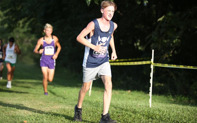 Devil runner freshman Ezra Adamson (left) is listed as No. 13 in the region for male runners. (Photo by Scoggins)