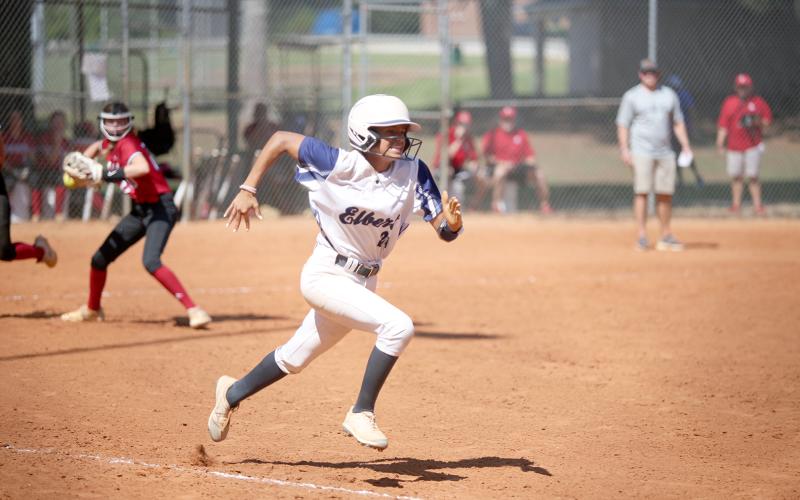 Lady Devil Carmen Burden sprints to first base as a Savannah Christian Lady Raider looks to throw her out during a tournament game in Winder Saturday, Aug. 27. (Photo by Scoggins)
