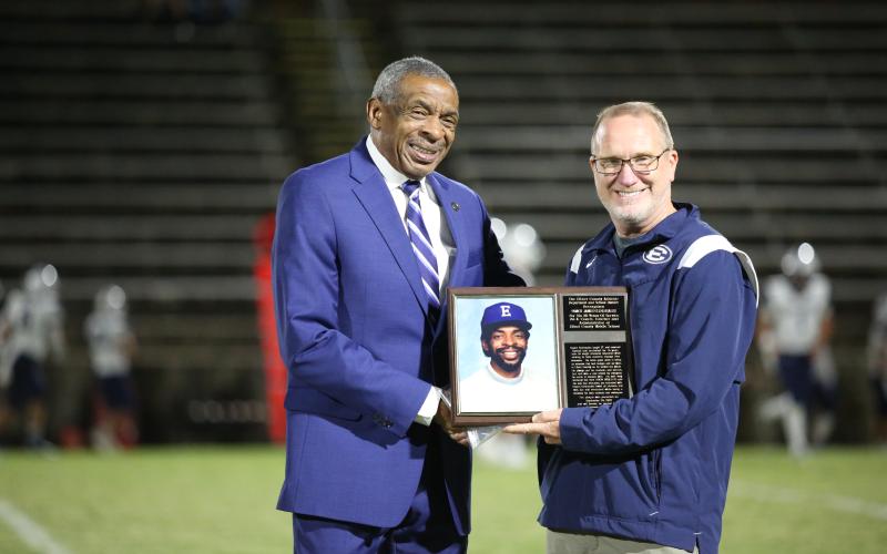 Coach James Clinkscales (left) was honored with a plaque by superintendent Jon Jarvis (right) during Thursday’s homecoming football game. (Photo by Scoggins)