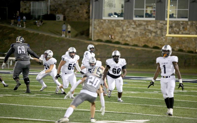 Junior Lucas Alcalde (No. 58), junior Eli Jourolmon (No. 52) and senior Curtis Hall (No. 60) block as sophomore quarterback Javyn Hickman makes a pass during the Devils’ 35-24 win over Whitefield Academy Oct. 7. (Photo by Scoggins)