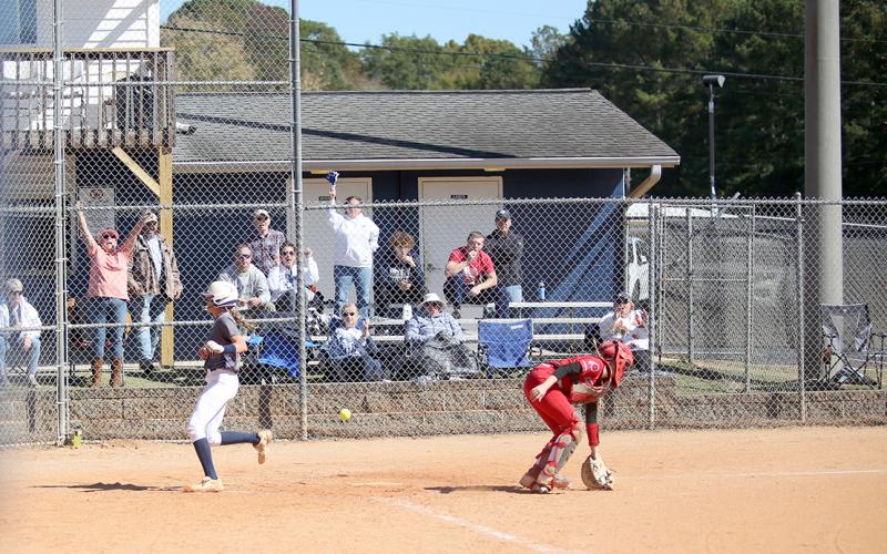 The crowd cheers as freshman Kamryn Webb safely crosses home plate during the Lady Devils’ season-ending 7-4 loss to Social Circle in the super regionals of the GHSA state playoffs Oct. 19. (Photo by Wells)