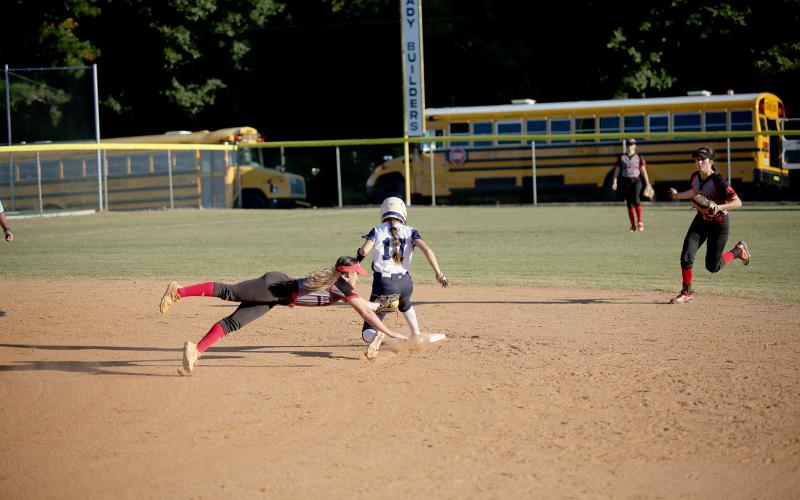 Hannah Brady safely slides past a Rabun County Lady Cat during the Devils’ 5-0 region win Oct. 4. The Lady Devils went on to secure the region championship after falling 4-0 to Commerce Oct. 6. (Photo by Wells)