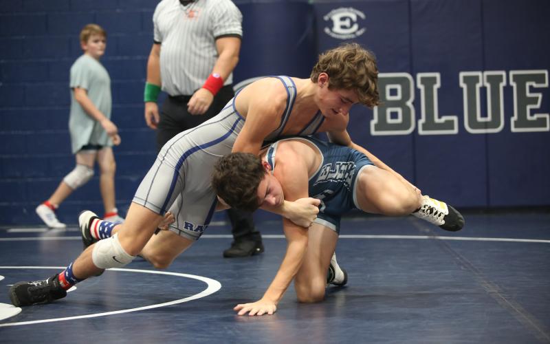 Eighth grader Rilee Rucker (gray) wrestles fellow eighth grade teammate Jackson Black (blue) during the Ram Invitational Saturday, Nov. 5 in the Inferno. The Rams kicked off their season with the home-opening invitational and placed first as a team. (Photo by Scoggins)