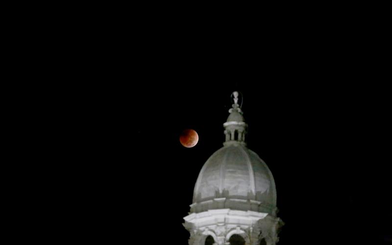 A total lunar eclipse took place between 5:16 a.m. and 6:41 a.m. over the East Coast of the United States Tuesday morning as the moon passed entirely into the Earth’s shadow. The beginning of the red eclipse could be seen just beyond the Historic Courthouse. According to NASA’s website, the next total lunar eclipse won’t take place again until March of 2025. (Photo by Scoggins)