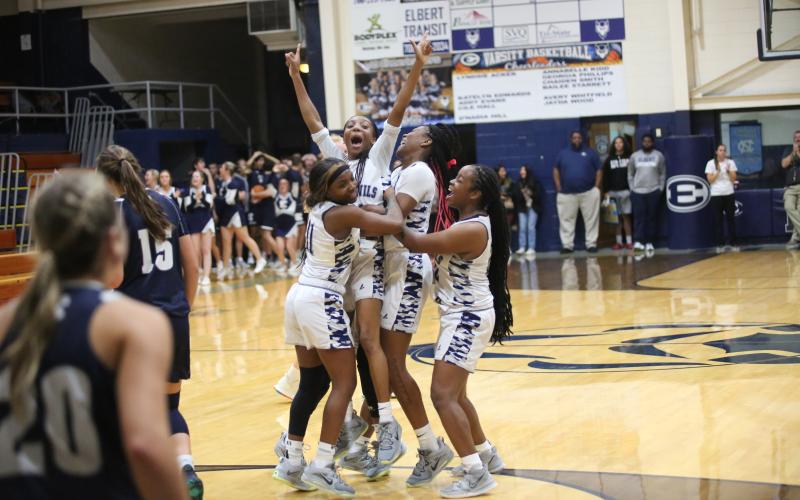Seniors (L-R) Terrace Hester, Niya Moon, Brenasia Faust and Jameria Allen celebrate a game-winning shot at the buzzer by Moon during the Lady Devils’ scrimmage over White County Nov. 10. (Photo by Wells)