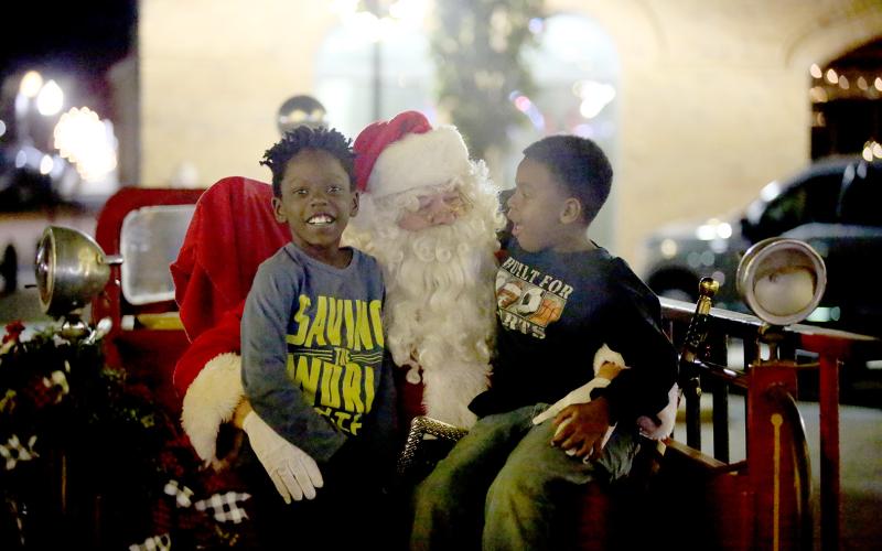 Main Street Elberton’s Candlelight Shop Night drew large crowds on the downtown square Tuesday, Nov. 22, including a visit from Santa Claus. Local merchants and small businesses opened their doors and booths, the County-Line Jazz Band performed with lighted instruments and the lighting of the city’s Christmas tree was officially held. (Photos by Scoggins)