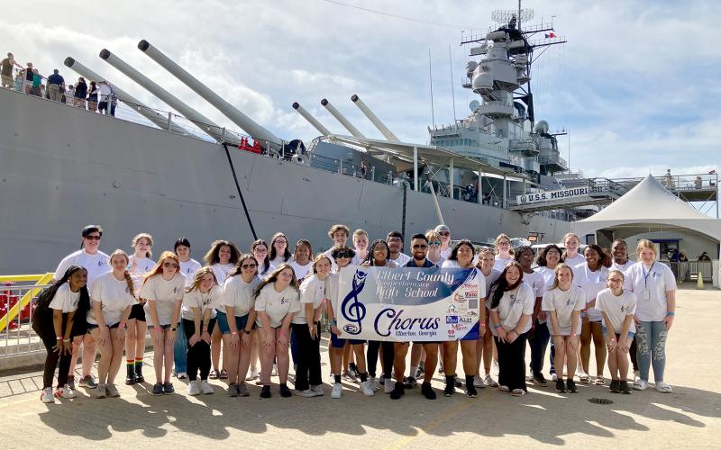 The Elbert County Chorus experienced a once-in-a-lifetime five-day trip to Hawaii and performed during the 81st annual commemoration of Pearl Harbor Wednesday, Dec. 7. Pictured in front of the U.S.S. Missouri Memorial at the Pearl Harbor Memorial in Honolulu, Hawaii are Elbert County High School Chorus members, Director Allyson Dye and the school’s tour guide.
