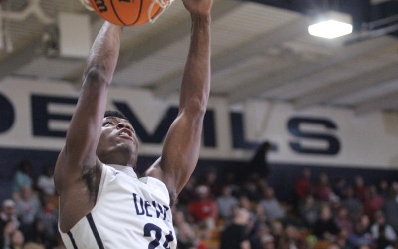 Senior Quan Moss makes a dunk during the Devils’ loss to Madison County Friday, Dec. 9 in the Inferno. (Photo by Wells)