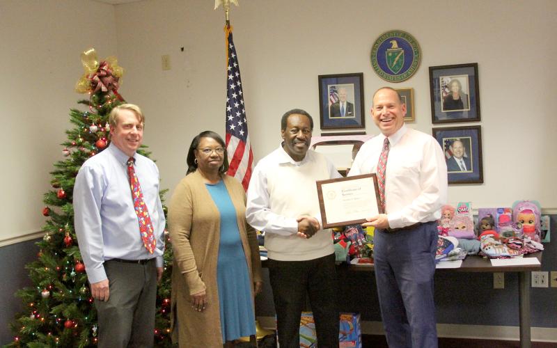 Pictured during a retirement luncheon for Freddie Baker honoring him for his 50 years of federal employment are (L-R) Southeastern Power Administration’s Leon Jourolmon, Baker’s wife Sarah, Baker and SEPA’s Virgil Hobbs. (Photo by Wells)