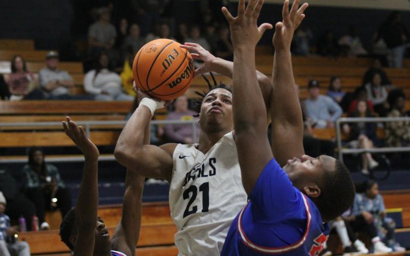 Senior Trustin Allen takes a shot between two Oglethorpe County defenders during the Devils’ 59-46 loss in the Inferno Dec. 17. (Photo by Wells)