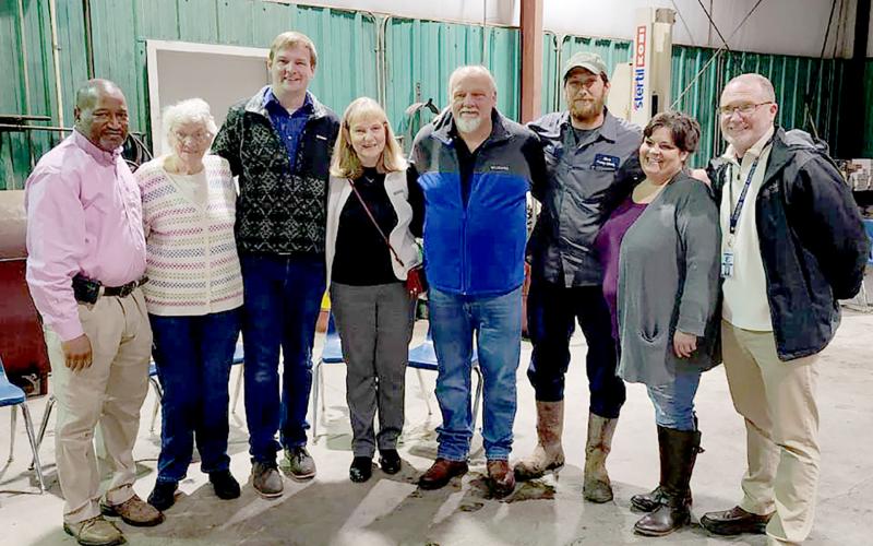 Pictured during a retirement party for former Elbert County School District Director of Transportation Mark Cartledge are (L-R) current director Darin Rucker, Peggy Cartledge, Caleb Cartledge, Carol Cartledge, Mark Cartledge, Clint Webb, Dawn Royston and Superintendent Jon Jarvis.