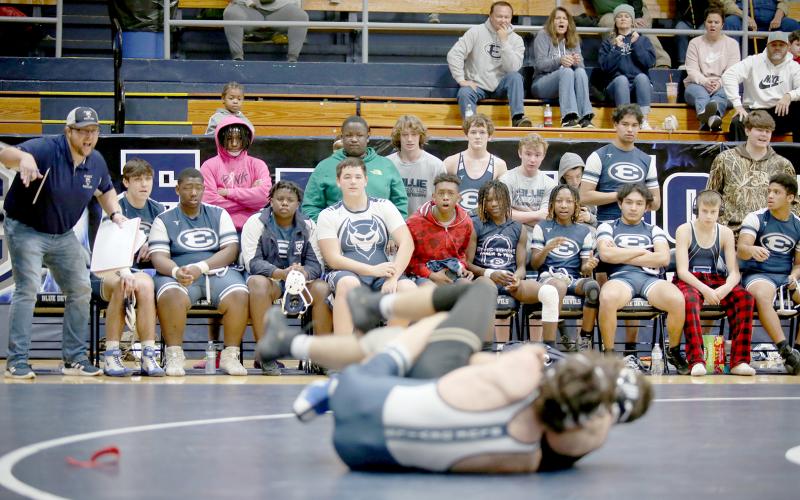 Mat Devils Head Coach Shane Anderson (far left) coaches Carter Fleming during a match against Commerce High School in the area duals Jan. 7 in the Inferno. Anderson hit his 200th dual win as a coach in December. (File photo by Scoggins)