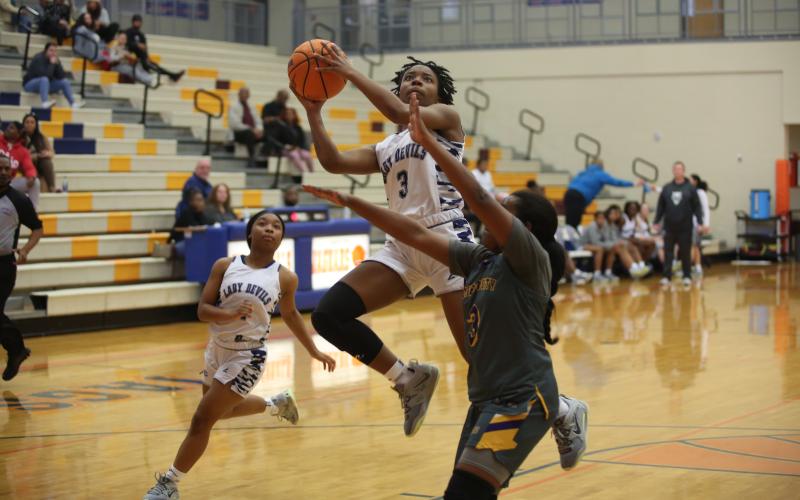 Aaniyah Allen soars to the basket during the Lady Devils’ 61-43 loss against AAAAA fifth-ranked Jones County during the Cedar Shoals Winter Classic Dec. 30. (Photo by Scoggins)