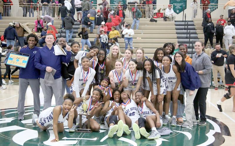 The Elbert County Lady Devils claimed the Region 8A-D1 championship trophy after defeating Rabun County 61-41 in the region tournament Feb. 17 at Piedmont University. The win came nearly one year after the Lady Devils lost the championship to the Lady Cats before ultimately defeating Rabun in the GHSA state championship. (Photo by Scoggins)
