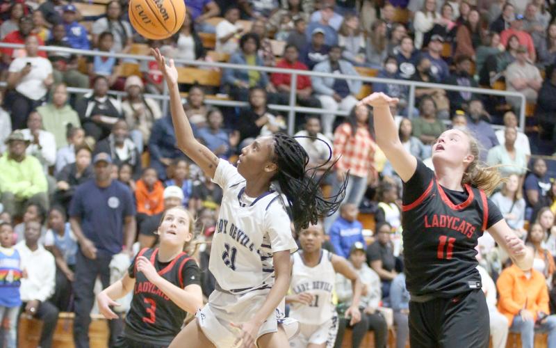 Niya Moon flies past Rabun County defenders to score during the Lady Devils win over Rabun Feb. 7. (Photo by Scoggins)
