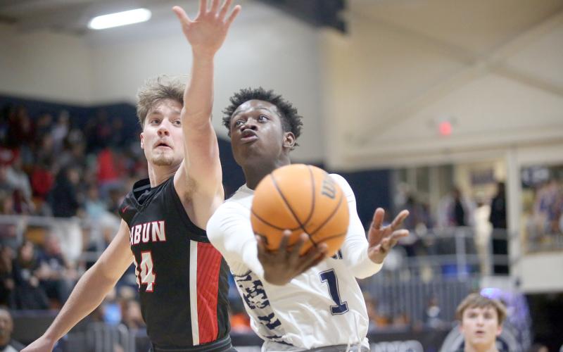 Blue Devil Bob Thomas goes for the goal during the Devils loss to Rabun County Feb. 7. The Devils claimed a spot in the Region 8A tournament and GHSA state playoffs by upsetting Commerce Monday night. (Photo by Wells)