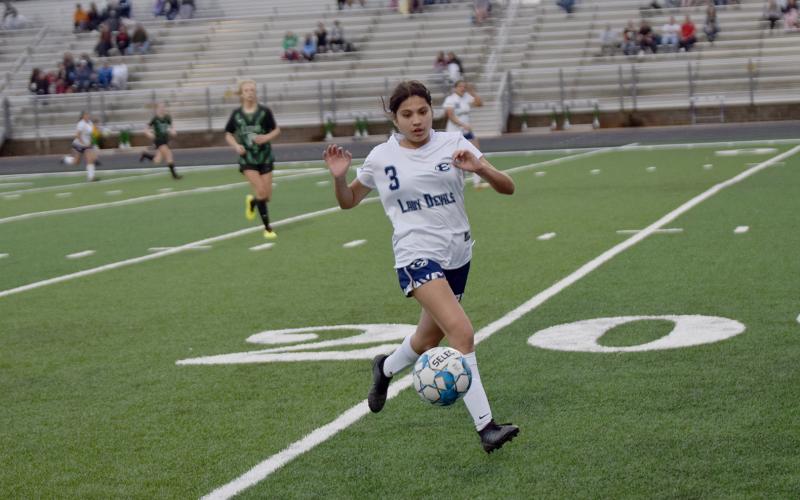 Lady Devil Linda Garcia takes the ball down the field in Carnesville Feb. 21. (Photo by Shane Scoggins, Franklin County Citizen Leader)