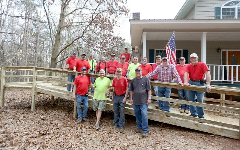First Baptist Church Ramp Ministry members pictured are (first row, L-R) Jarrod Gunn, Keith Madden, Sam Pagett and Blaine Worley; (second row, L-R) Kyle Branan, Tim Adams, Larry Gillham, Bill Palmer, James Adams, Steve Hall, Bobby Jones, William Loggins, Kyle Brown, Charlie Roberts, Steve Rousey and Harley Thomas; (third row, L-R) Richey Eckler and ramp recipient Neil Summerour. (Photo by Scoggins)