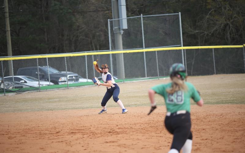 Ava Lunsford throws in a ball during the Lady Devils’ slow pitch softball game against Franklin County High School March 16. (Photo by Wells)