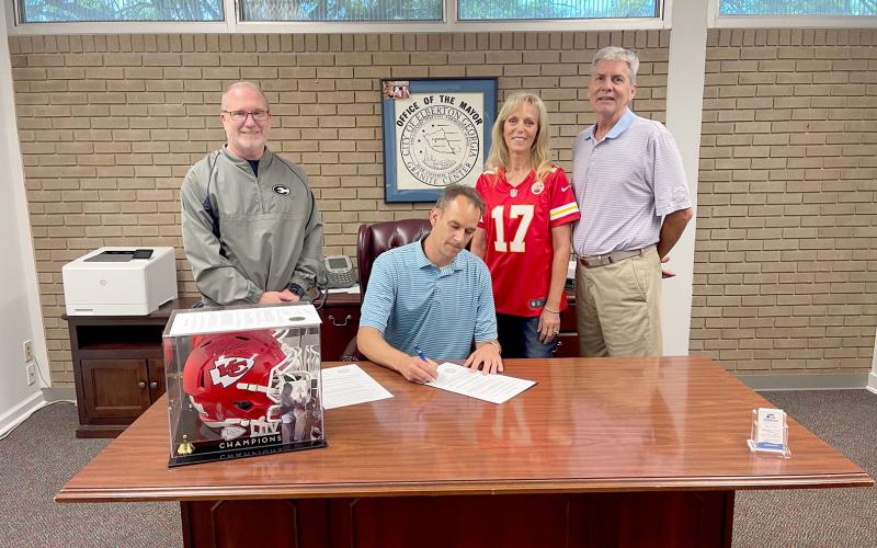 Pictured during a proclamation signing for Mecole Hardman Jr. week leading up to the Friends Helping Friends (FHF) annual pageant and live action are (L-R) Superintendent Jon Jarvis, Mayor Daniel Graves, FHF Founding President Sandy Adams and Jeff Adams.