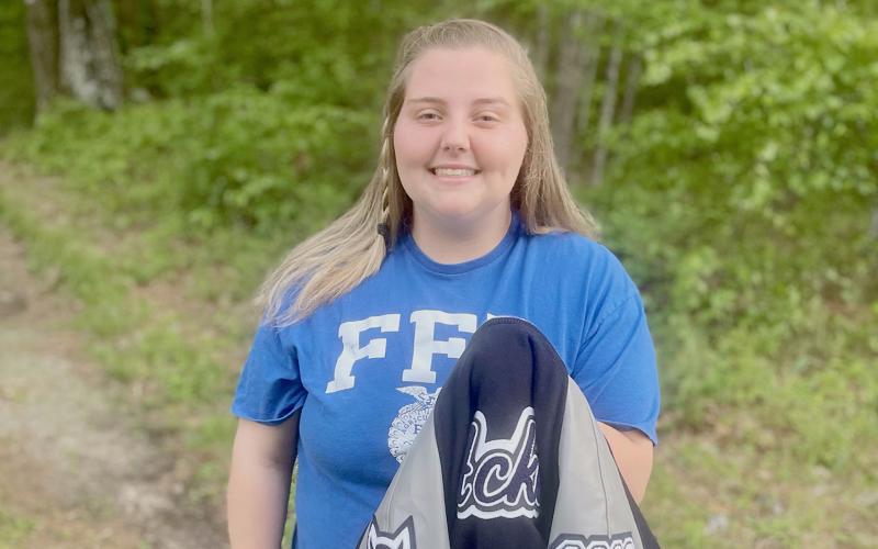 ECCHS senior Natalie Acker (left) holds the first letterman jacket obtained by being an FFA Club member.