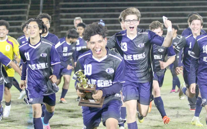 Blue Devils (L-R) Brandon Salazar (No. 11), Chapo Serna (No. 10), Nick Smith (No. 13) and Ian Lavere (No. 1) celebrate the Devils’ win over Barrow March 30 that propelled them to a historic finish as the No. 2 seed in Region 8A-D1. (Photo by Wells)