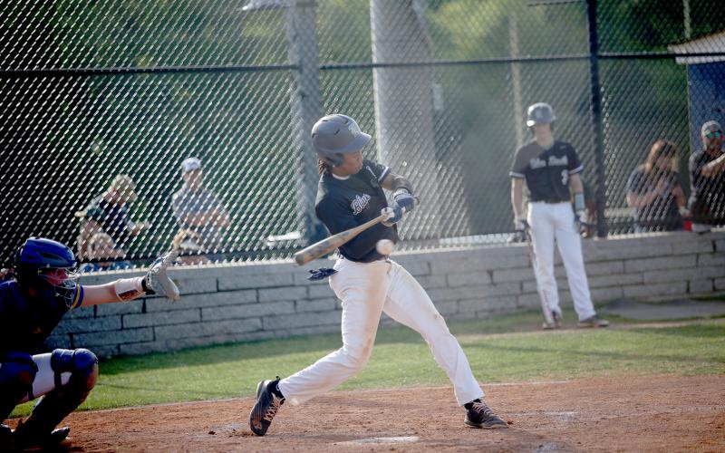 Senior Trustin Allen puts the ball in play during the Diamond Devils’ 14-3 win over Washington Wilkes April 19. (Photo by Wells)