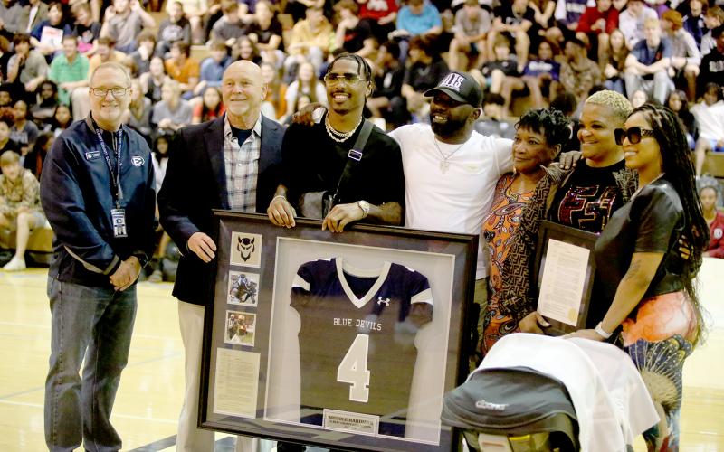 Pictured during the presentation are (L-R) Superintendent Jon Jarvis, former head football coach Sid Fritts, Hardman, Mecole Hardman Sr., Mae Sue Hardman, Danyell Hardman and Chariyah Gordon. (Photo by Scoggins)