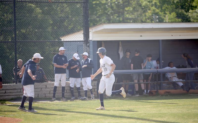 Diamond Devil Lawson Adams high-fives Head Coach Lance Ingram as he trots down the third-base line following his first-inning home run in Elbert’s 8-7 loss to Social Circle in the first game of the Sweet Sixteen series. (Photo by Wells)
