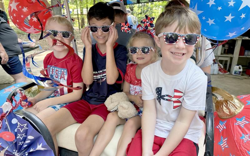 Pictured during the parade are (above, L-R) Max Truitt, Jace Merena, Lillie Chicken and James Truitt.