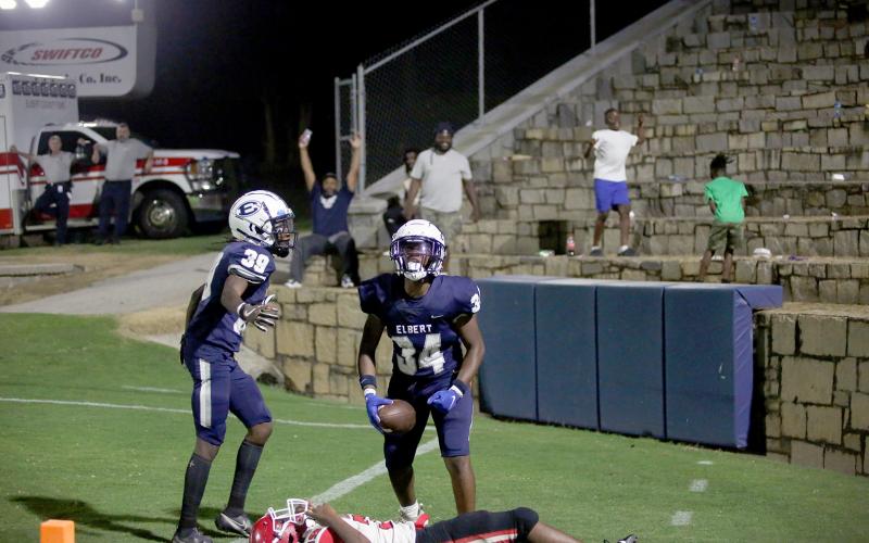 Sophomore Jaylen Davis (No. 39) celebrates with freshman Exavier Jones (No. 34) and a handful of Blue Devil fans following a pair of late-game touchdowns that led the Blue Devils to a 22-10 victory in the pre-season scrimmage against Stephens County in the Granite Bowl Aug. 4. (Photo by Wells)