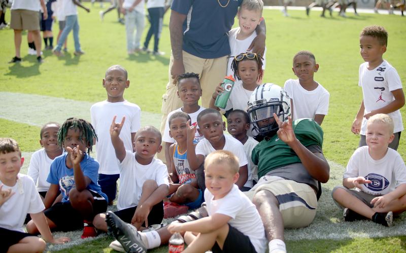 Blue Devil pride was on display Aug. 11 as the football team participated in two community events to get them ready to kick off the season. Above, Elbert County Parks and Recreation players pose for a photo with quarterback Jayvyn Hickman at the Granite Bowl kickoff event hosted by the True Blue Booster Club.