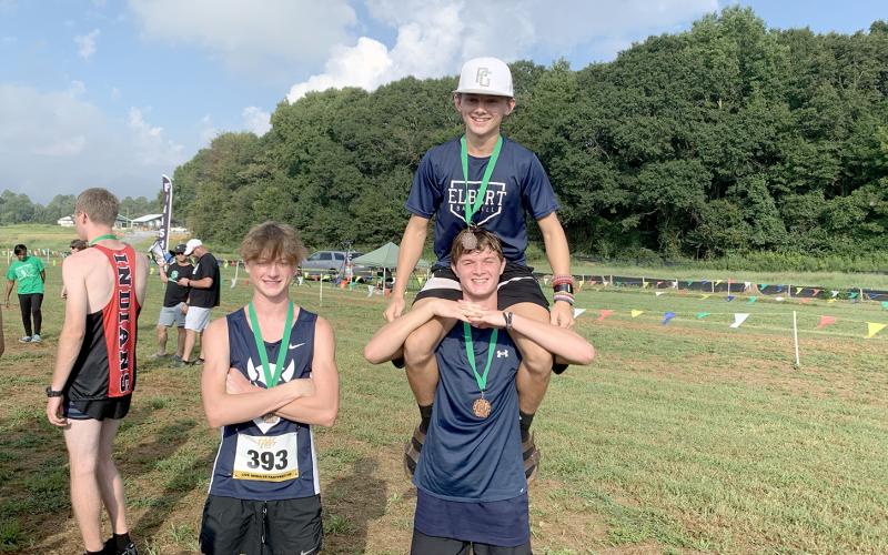 Ezra Adamson, (top) Dakota Toole and (bottom) Connor Holland pose with their Top 10 medals after the meet in Franklin County Sept. 9. (Photo by Wells)
