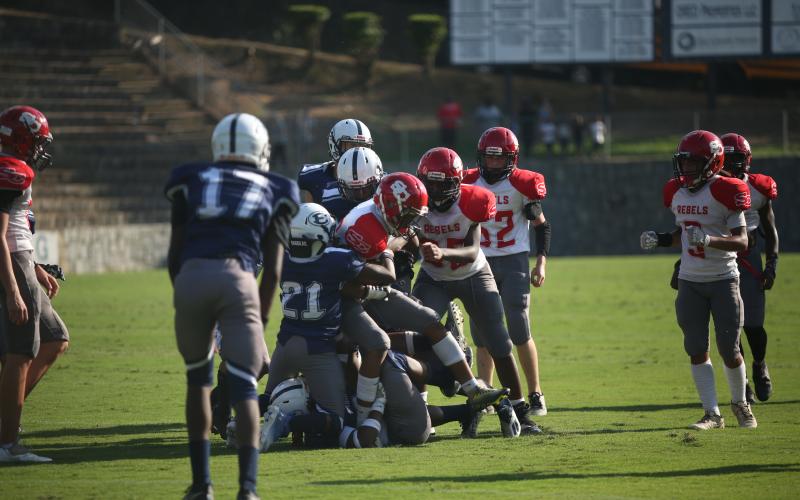A host of Rams lift the Stephens runner off the ground and tackle him in a 22-0 loss to Stephens Aug. 31. (Photo by Wells)