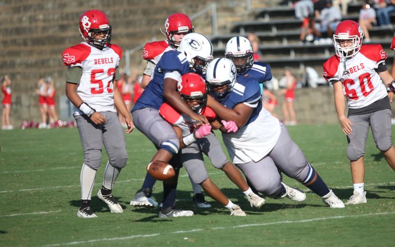 A pair of Rams tackle a Stephens County player as the ball pops loose for a fumble in Elbert’s 22-0 loss to the Rebels Aug. 31. (Photo by Wells)