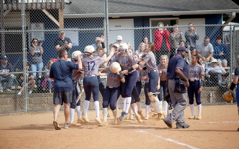 The Lady Devils swarm Ky Dubose at the plate after she hit a home run in Elbert’s game against Trion Oct. 19.  (Photo by Wells)